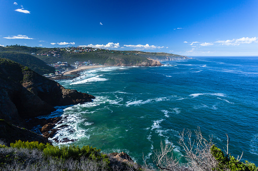 Herolds Bay holiday town along ocean coastline from high cliffs overlooking scenic landscape.