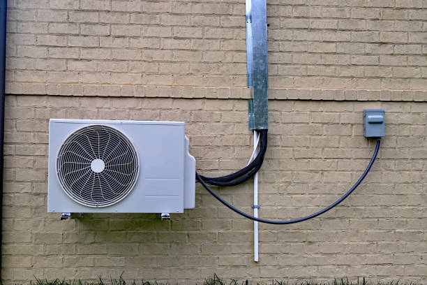 istock Air Conditioner mini split system next to home with brick wall 1064710692