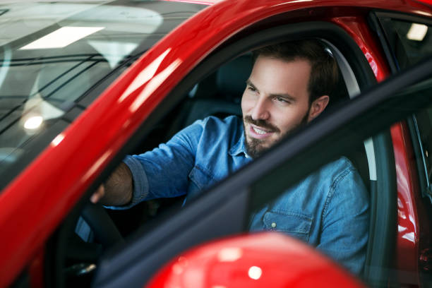 istock Young man in a brand new car 1064711510