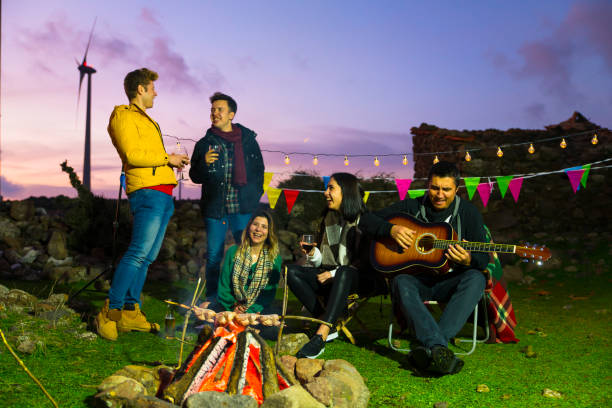 istock Cheerful friends having fun by the campfire during the autumn 1064720642