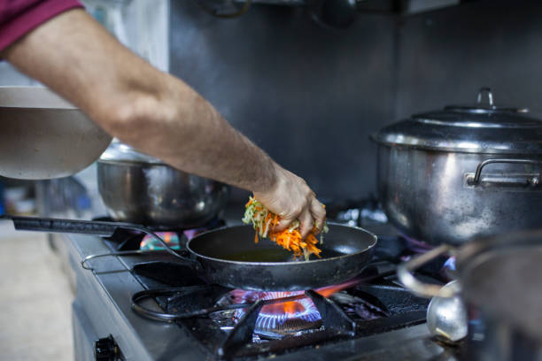 istock chef is cooking vegatabels with saute pan 1064723590