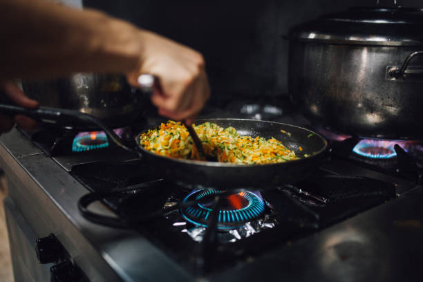 istock chef is cooking vegatabels with saute pan 1064724814