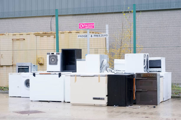 istock Old fridges freezers refrigerant gas at refuse dump skip recycle stacked pile plant help environment reduce pollution white silver 1064724900