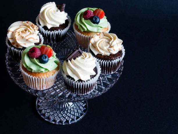istock Tasty cupcake with fresh fruit on dark background. 1064725314