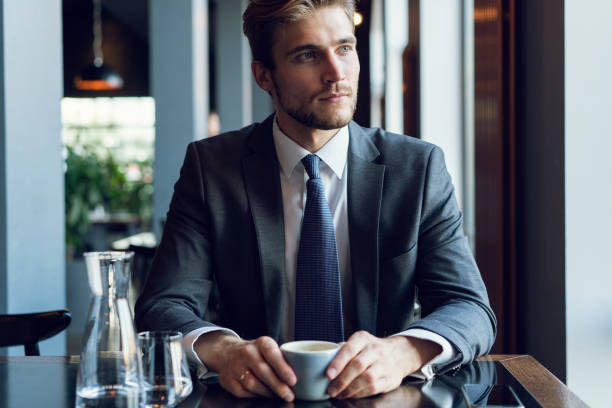 istock Business man drinking coffee in a cafe 1064725340
