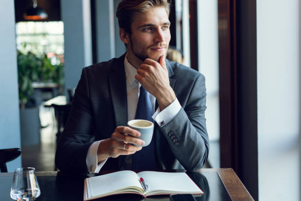 istock Business man drinking coffee in a cafe 1064725342