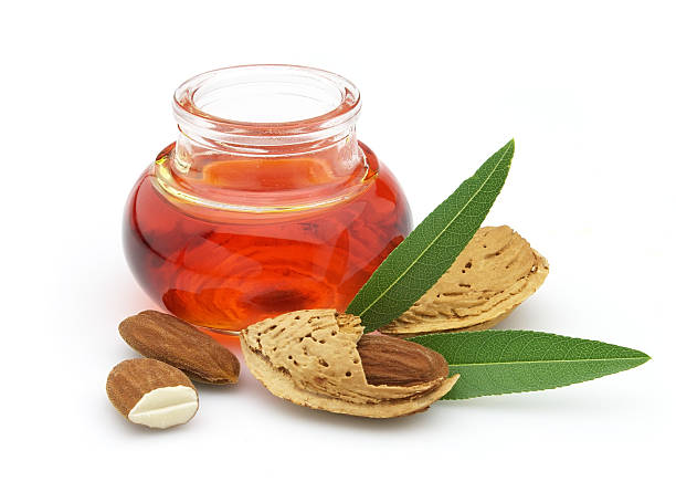 istock Fresh raw almonds next to jar of oil 106472576