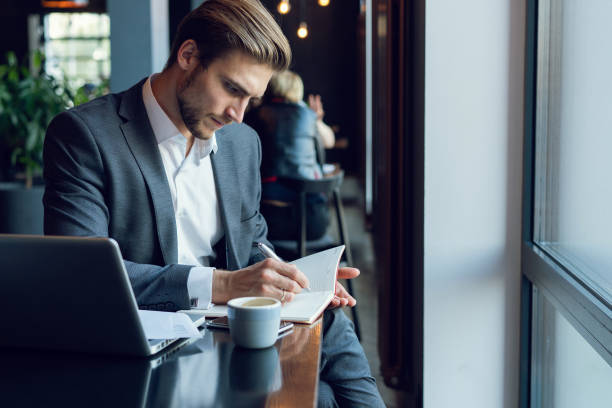 istock Businessman doing his work and having coffee in cafe 1064725836