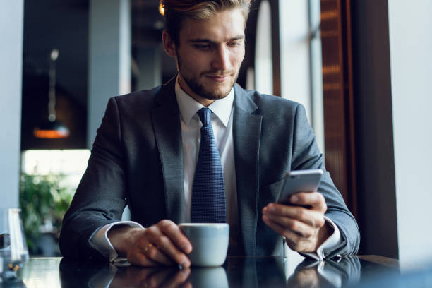 istock Young man drinking coffee in cafe and using phone. 1064727032