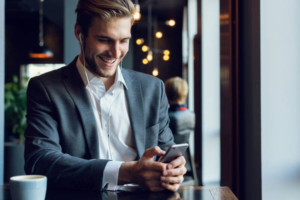 istock Young man drinking coffee in cafe and using phone. 1064727034