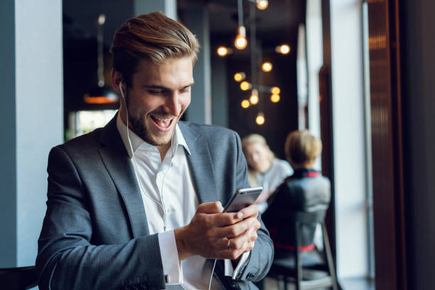 istock Young man drinking coffee in cafe and using phone. 1064727036