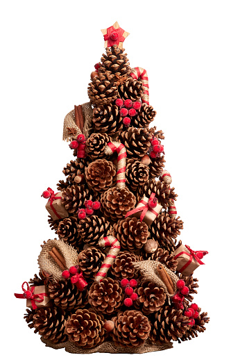 Christmas tree made of cones decorated with cinnamon sticks, nutmeg. Hand-made. Element for Christmas and New Year design. Isolated on white