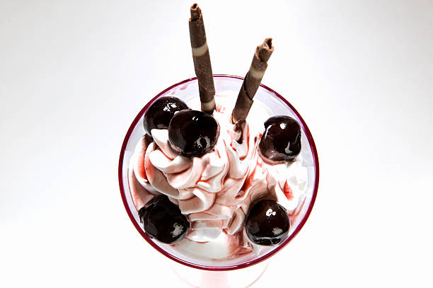ice coupe with fruit, cream, spoon on terrace table
