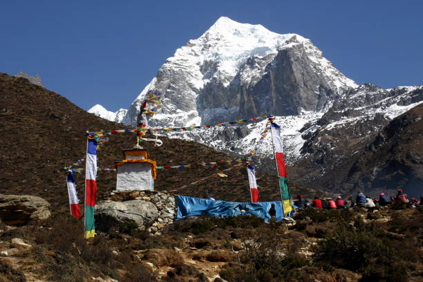 istock buddhist celebration and prayer flag in Khumbu with high peak 1064729324