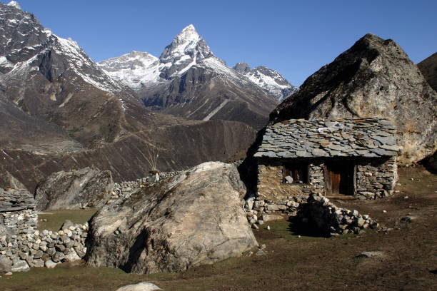 istock stone barn in Khumbu with high peak 1064729342
