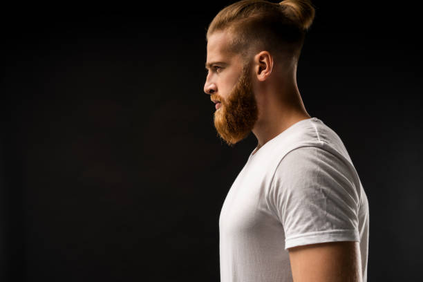 istock Side view portrait of thinking stylish young man looking away. 1064730076
