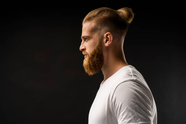 istock Side view portrait of thinking stylish young man looking away. 1064730084