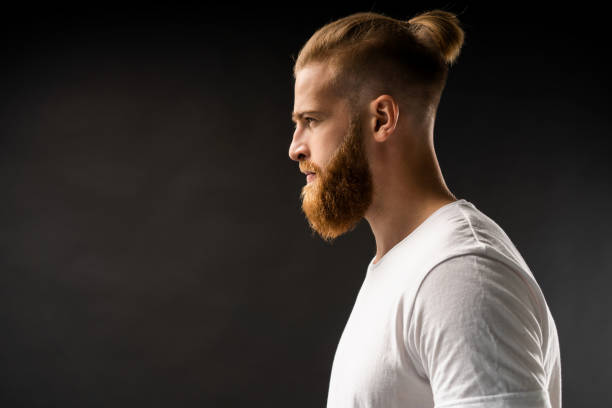 istock Side view portrait of thinking stylish young man looking away. 1064730088