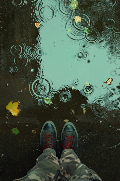 istock Standing in the drizzle puddle on the street 1064730582