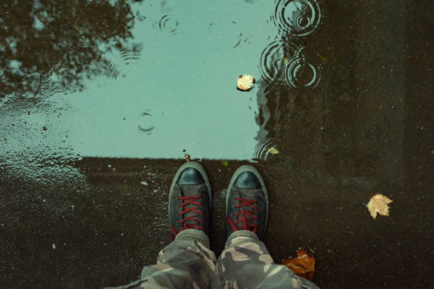 istock Standing in the drizzle puddle on the street 1064730758