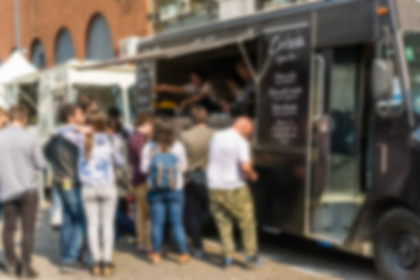 People at a street food market festival on a sunny day. Blurred on purpose. People at a street food market festival on a sunny day. Blurred on purpose. food festival stock pictures, royalty-free photos & images