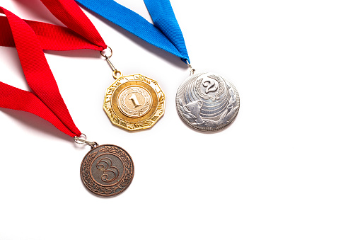 Gold, silver and bronze medals with ribbon on white background. Isolated. Copy space