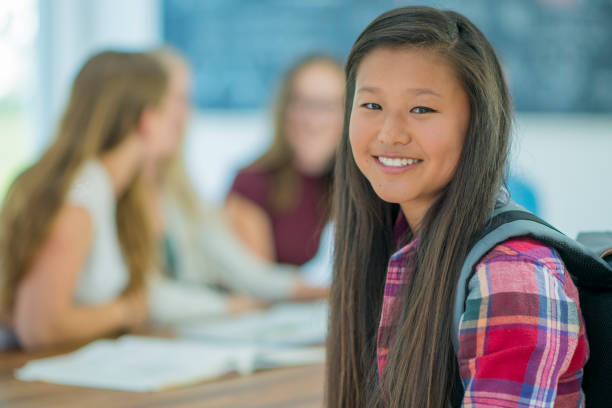 istock Young woman smiling in classroom 1064732604