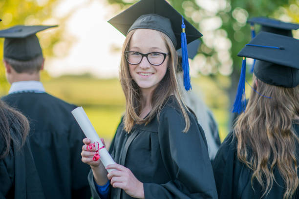istock Graduating woman with diploma 1064732624