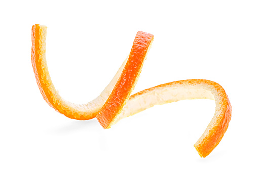 Twisted orange skin on a white background. Orange zest spiral.