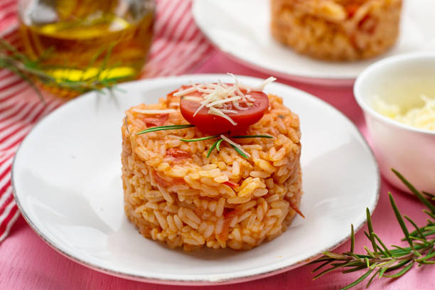 Tasty tomato rice with grated cheese Tasty tomato rice with grated cheese and tomato sauce tomato rice stock pictures, royalty-free photos & images