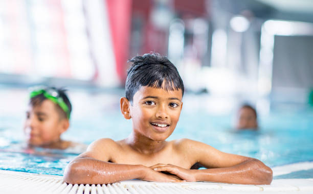 istock Smiling boy in swimming pool 1064735864
