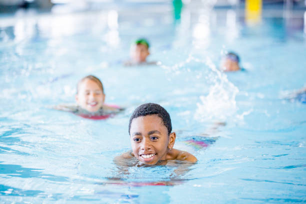 istock Children learning to swim in a pool 1064735876