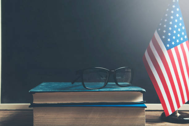 istock books and USA flag on dark background 1064736054