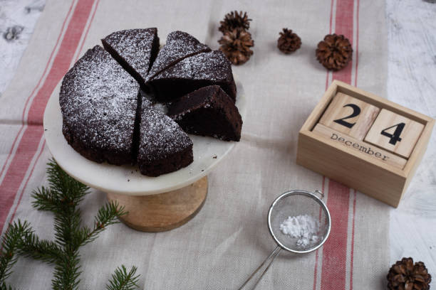 istock Christmas cake or Chocolate Brownie and decorations on white table 1064739968