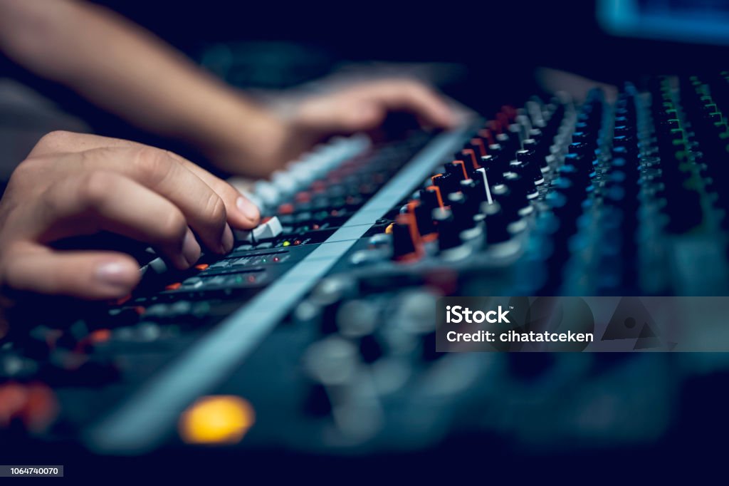 Hand with sound recording studio mixer Young male dj works in modern broadcasting studio Music Stock Photo