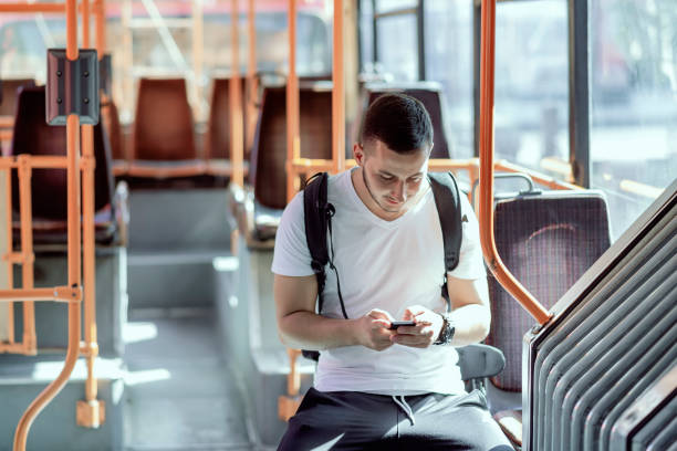 istock Young Man in the Bus with Smart Phone 1064740088