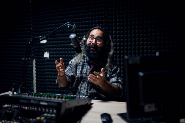 istock Young male DJ is asking guest question in modern broadcasting studio 1064740576