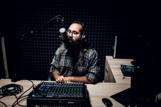 istock Young male dj works in modern broadcasting studio 1064740744