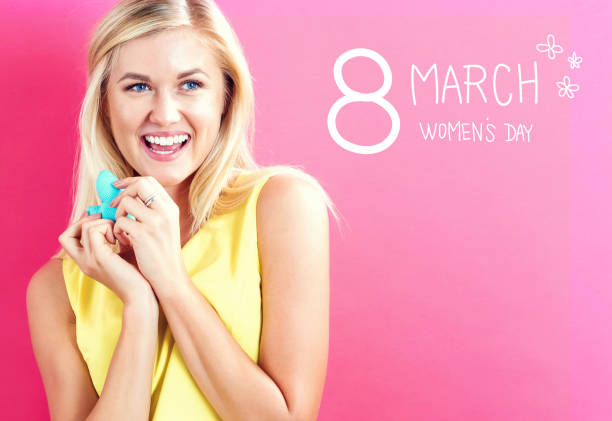 istock Women's Day text with woman holding a heart 1064745970