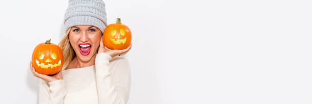 istock Young woman holding pumpkins 1064746274