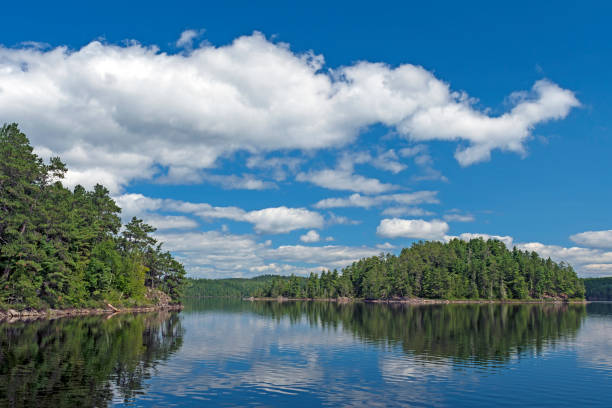 istock Puffy Clouds in Summer in the North Woods 1064748072