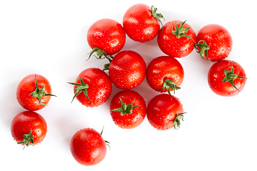 wet red cherry tomatoes isolated on white