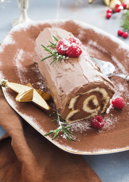 istock Chocolate yule log Christmas cake with  raspberries. 1064757914