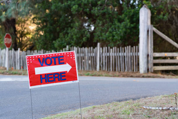 "Vote Here" sign in rural area with fence, gate and road for elections in USA Vote Here sign in rural area with fence, gate and road for elections in USA mendocino photos stock pictures, royalty-free photos & images