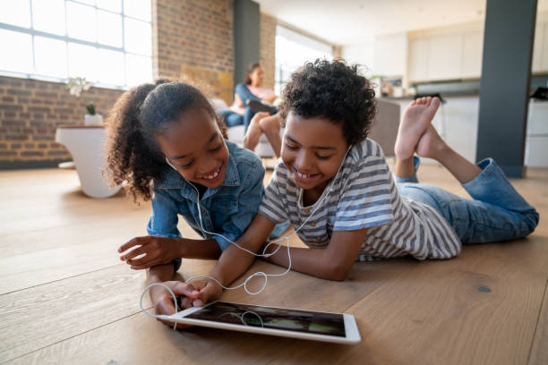 istock Happy kids at home watching videos on a tablet computer 1064761886