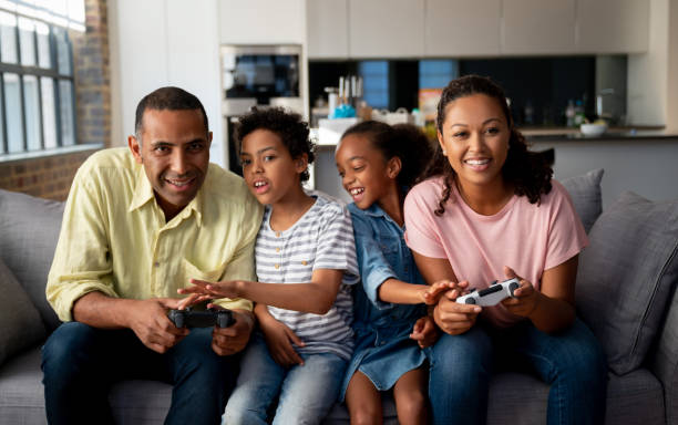 istock Family having fun playing video games at home 1064761942