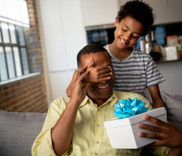 istock Happy boy surprising his father with a gift for Father's Day 1064761962