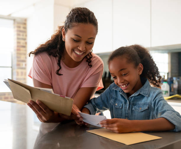 istock Happy mother checking the mail at home with her daughter 1064761984