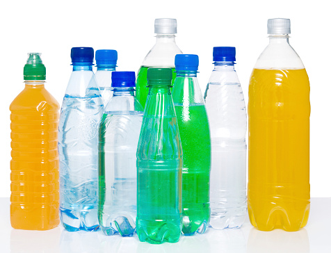 Mineral water in green glass bottle with water condensation and ice crystals isolated on white background.