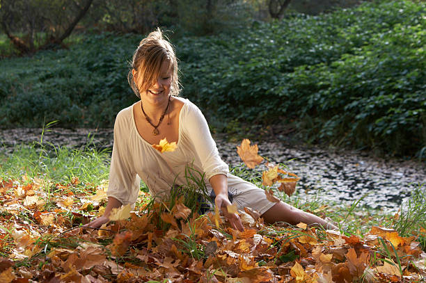 Girl throws leaves stock photo